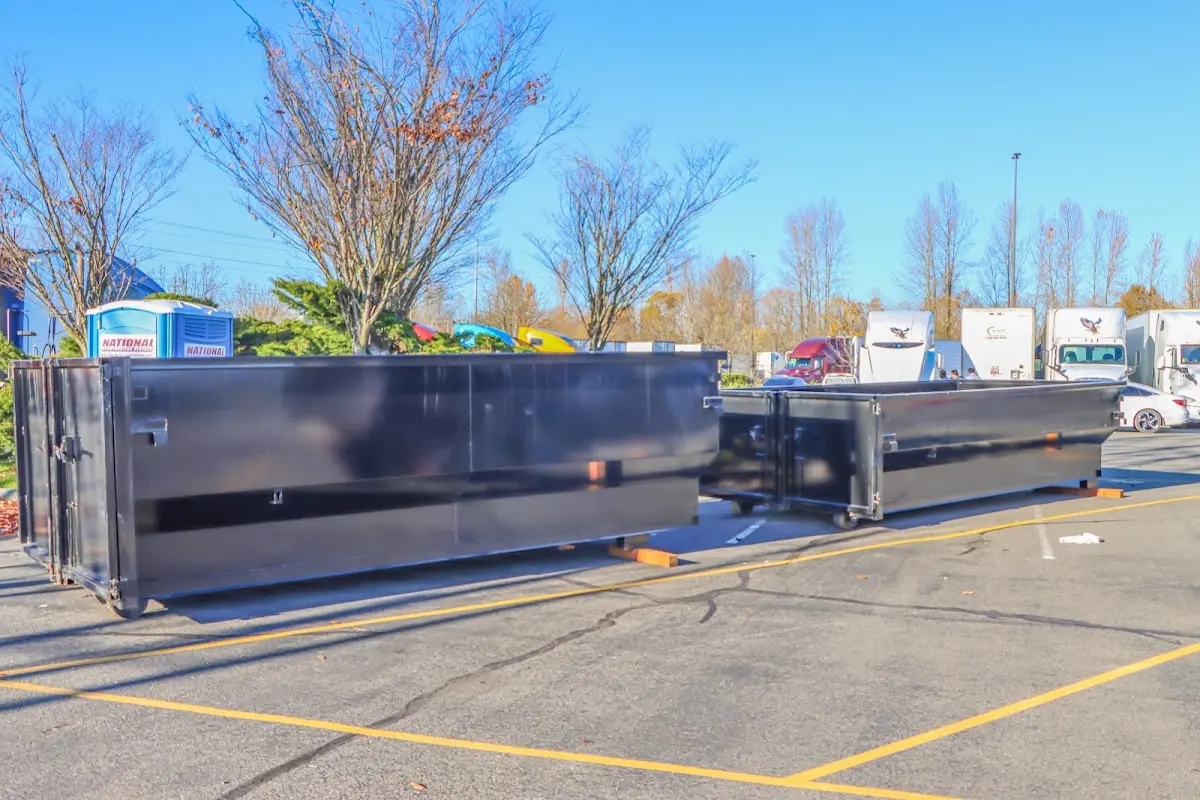 Professional dumpster rental service with roll-off container on residential driveway in Helena Valley Southeast